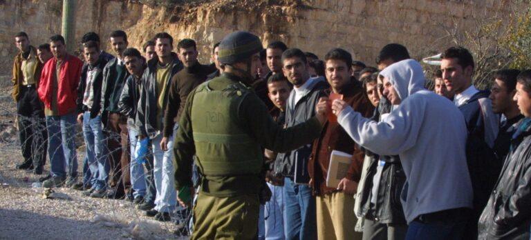 Palestinian students remonstrate with Israeli soldier at checkpoint