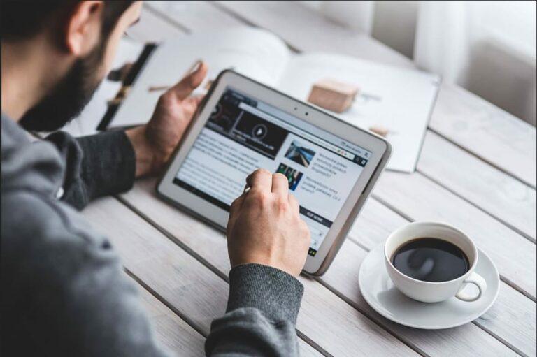 Man using tablet plus coffee