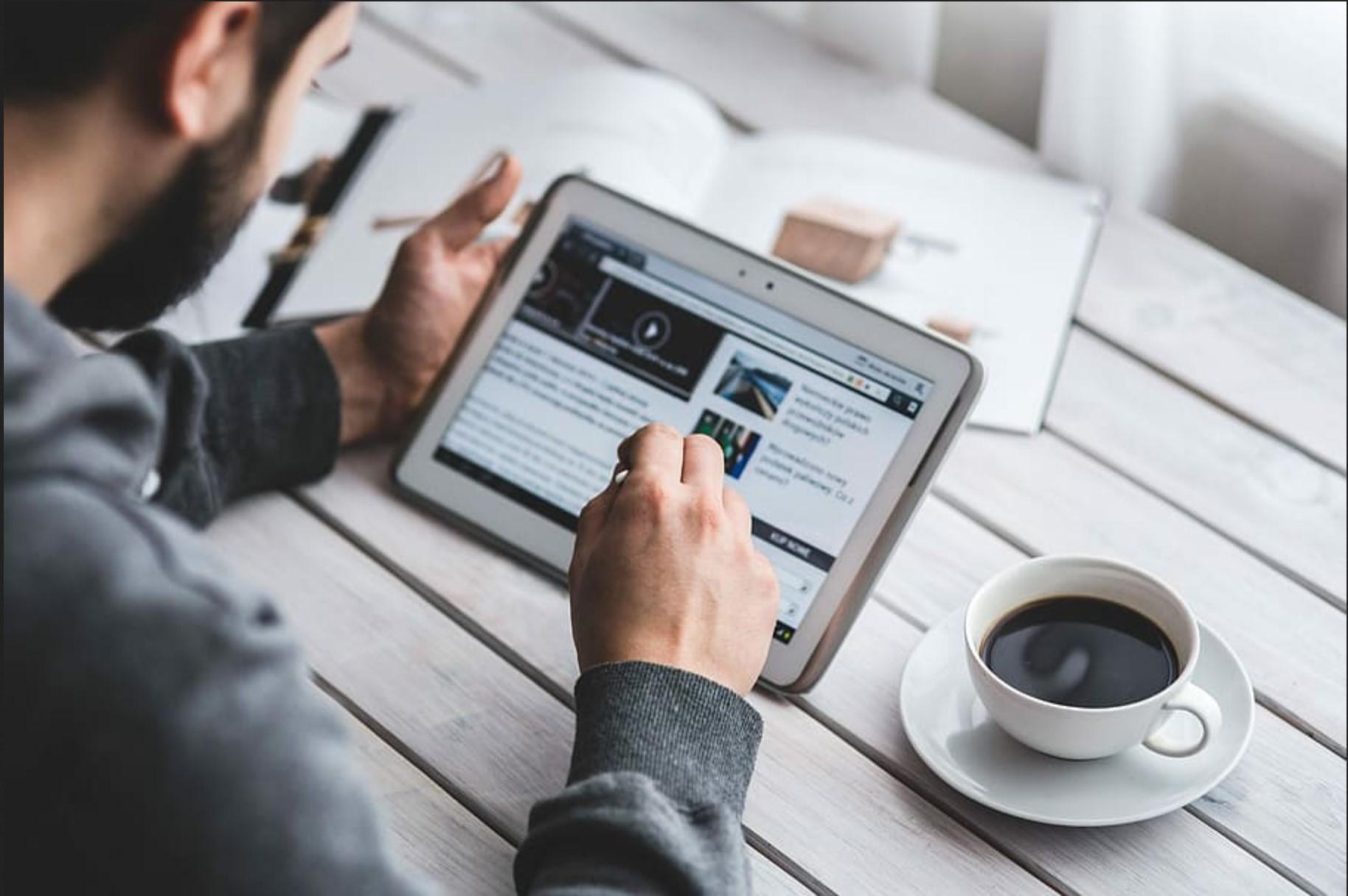 Man using tablet plus coffee